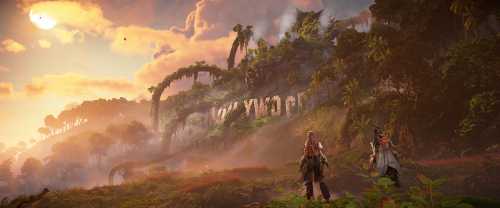 Game screenshot showing Aloy and Seyka looking at the iconic Holywood sign in the Horizon world, with a deactivated Horus over it.